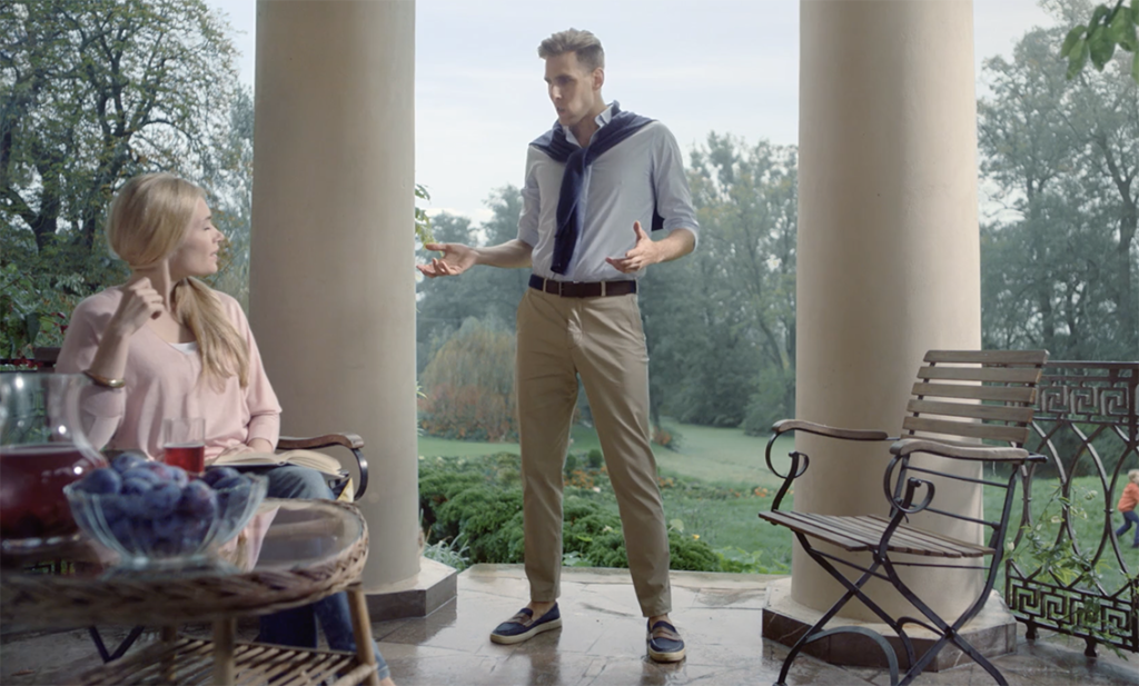 A scene from an AXA ad with an elegant man with his wife in his manor eating plum